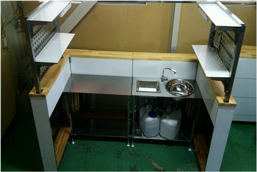 ブースキッチンの内側にガスボンベや水道の蛇口が付いてる写真