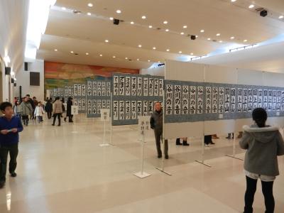 ボードに展示された作品を眺めている来場者たちの写真
