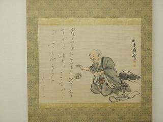 良寛手まりと人の絵が描かれた掛け軸の写真