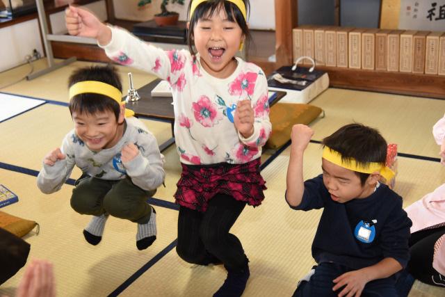 勝利のガッツポーズを決めている子ども達3人組の様子の写真