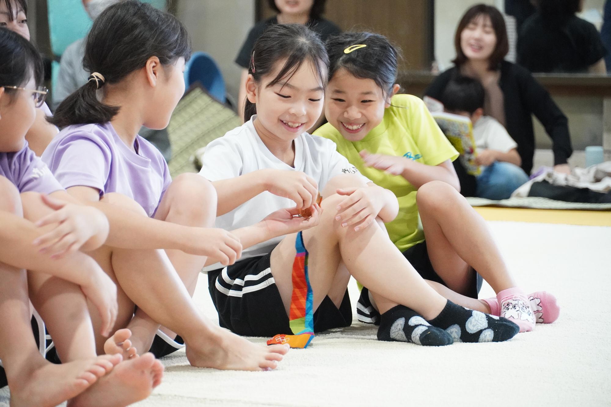 金メダルを手にして微笑む子どもたち