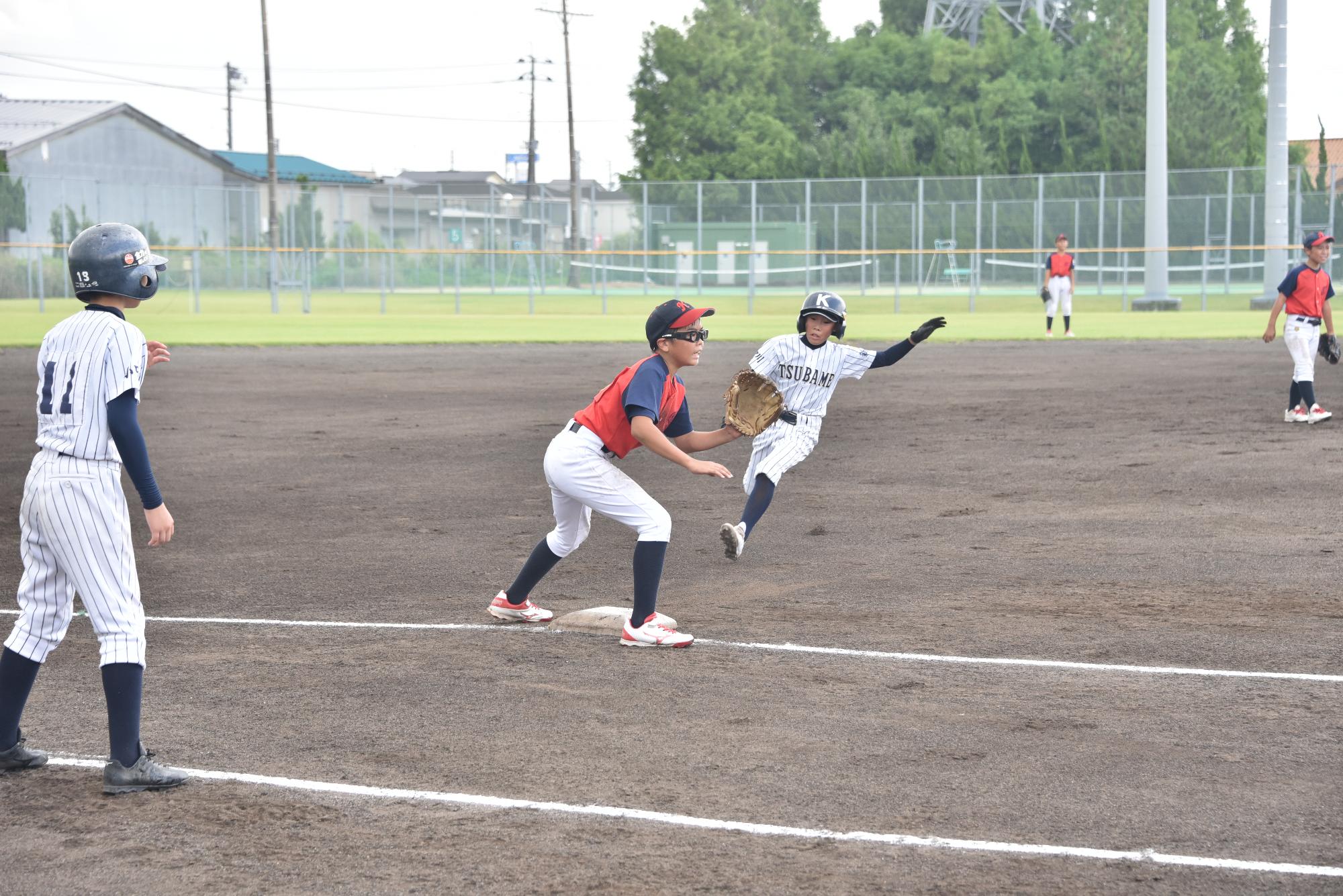 盗塁をするランナーと球を受ける三塁手