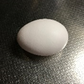 テーブルの上に、白い卵が一つ置いてある写真