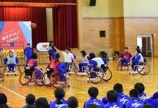 車椅子に乗りバスケットボールをする児童たちの写真
